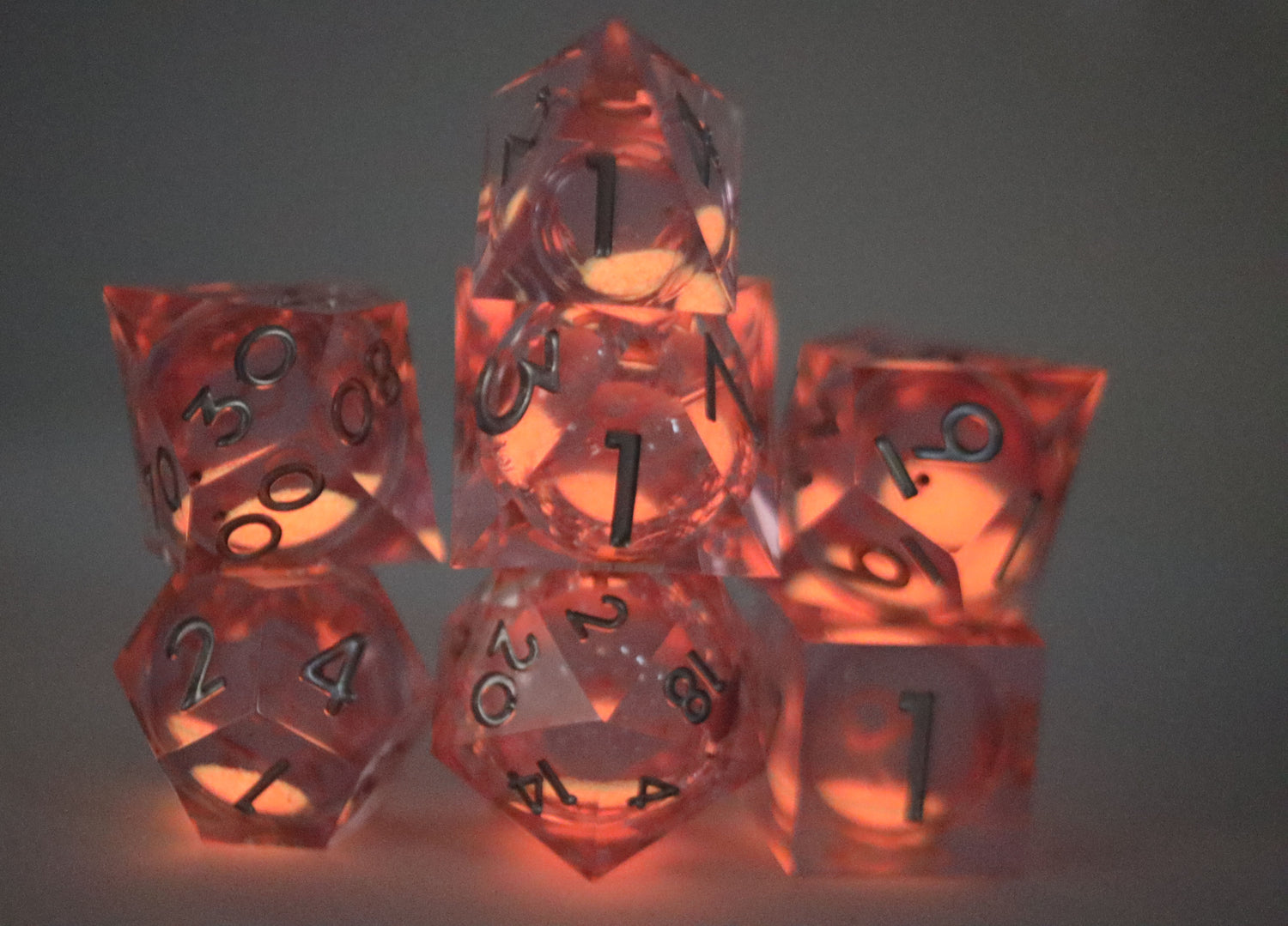 Sharp Edge Glow in the Dark Liquid Core RPG Dice Set - Radiant Pink Plastic Dice Foam Brain Games