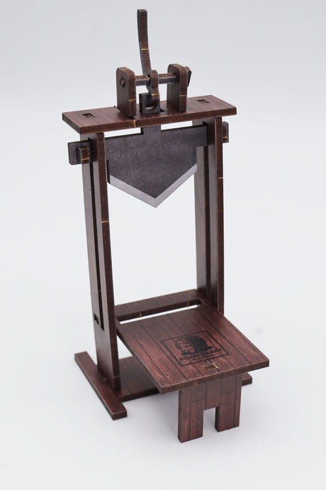 Foam Brain Games Assembled brown MDF Dice Guillotine with gray MDF blade in the up position, front view